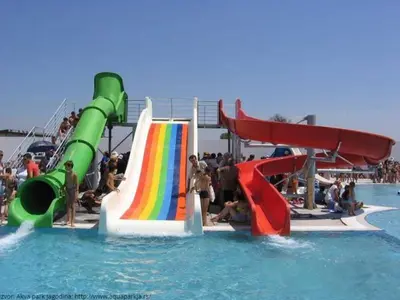 a water park with slides and people in the water at leoben in Jagodina