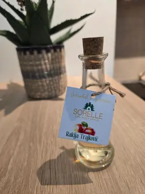 a bottle of seasoning sitting on a table with a plant at Apartman Sorelle in Vrnjačka Banja