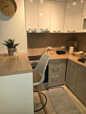 a kitchen with a table and a chair in it at Apartman Sorelle in Vrnjačka Banja