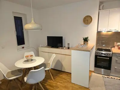 a small kitchen with a table and a small table and chairs at Apartman Sorelle in Vrnjačka Banja