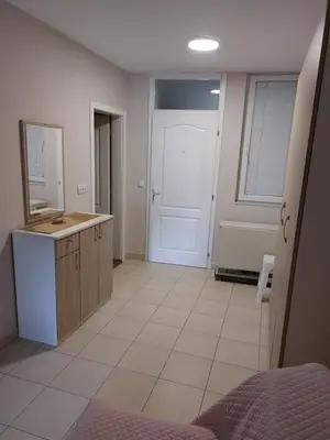 a room with a bathroom with a sink and a door at Apartments MIMOZA in Jagodina
