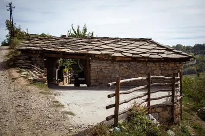 a small stone building with a roof at Porodična kuća Vitina Iža in Pirot