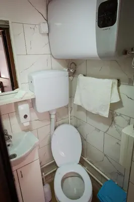 a small bathroom with a toilet and a sink at Porodična kuća Vitina Iža in Pirot