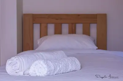 a pair of towels sitting on top of a bed at Restoran Lisine - Resavska pećina in Despotovac