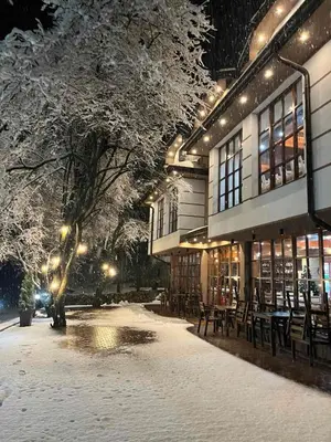 a building with tables and chairs in the snow at Restoran Lisine - Resavska pećina in Despotovac