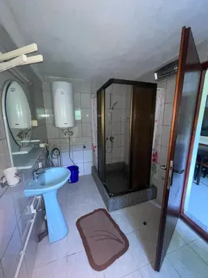 a bathroom with a shower and a sink and a toilet at Apartman Jošanička Banja in Jošanička Banja