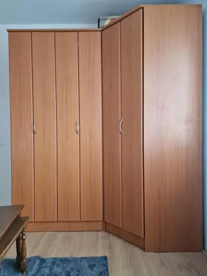 a closet with wooden cabinets in a room at Jasemin in Ćuprija