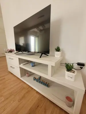 a white entertainment center with a television on it at Apartman Magnolija in Vrnjačka Banja