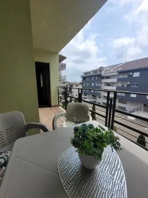 a table with a plant on top of a balcony at Apartman Magnolija in Vrnjačka Banja