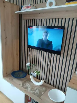 a flat screen tv hanging on a wall at Natura Lux & Parking Free - Green Hill, blizu Akva parka in Soko Banja
