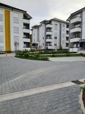 a parking lot with apartment buildings in the background at Natura Lux & Parking Free - Green Hill, blizu Akva parka in Soko Banja