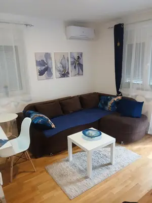 a living room with a couch and a coffee table at Natura Lux & Parking Free - Green Hill, blizu Akva parka in Soko Banja