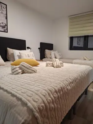 two large beds with pillows on them in a room at Apartmani Sunce Stara planina in Crni Vrh