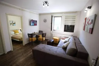 a living room with a couch and a bedroom at Apartmani Sunce Stara planina in Crni Vrh
