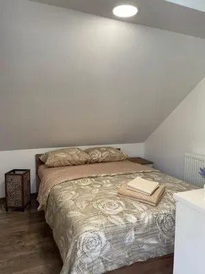 a bedroom with a bed with two towels on it at Apartmani Vrla NEW in Vladičin Han