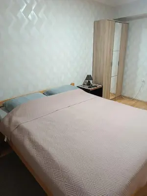 a bedroom with a bed and a dresser with a mirror at APARTMAN Buba in Pirot