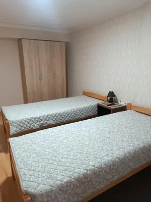 a bedroom with two beds and a dresser at APARTMAN Buba in Pirot
