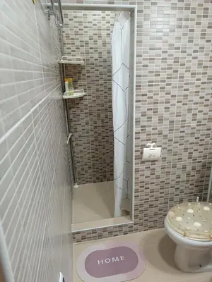 a bathroom with a toilet and a sign that says home at APARTMAN Buba in Pirot