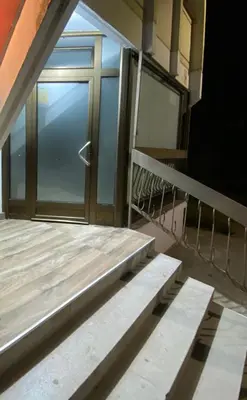 a balcony with a glass door on a building at Vito Apartman - Free Parking in Vranje