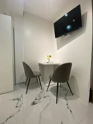 a dining room with two chairs and a table at Vito Apartman - Free Parking in Vranje