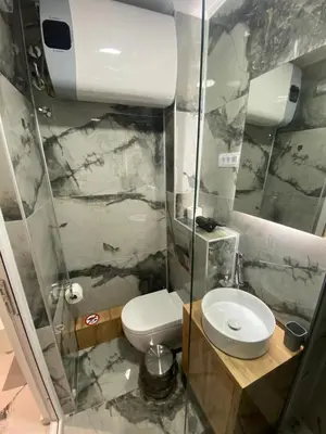 a bathroom with a toilet and a glass shower at Vito Apartman - Free Parking in Vranje