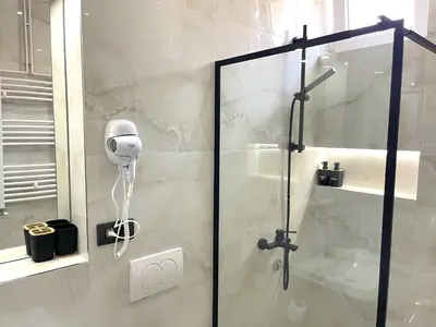 a shower with a glass door in a bathroom at LAGUNA Apartments in Vranje