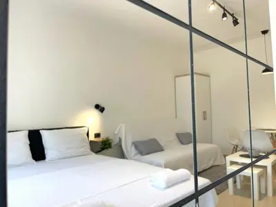 a bedroom with a bed and a mirror at LAGUNA Apartments in Vranje