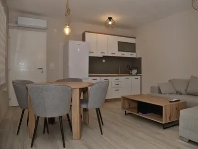 a kitchen and living room with a table and chairs at 4-teen in Jagodina