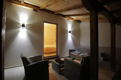 a room with two chairs and a mirror and a bed at 4-teen in Jagodina
