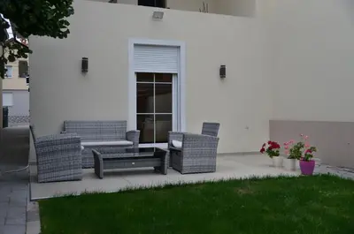 two wicker chairs and a table on a patio at 4-teen in Jagodina