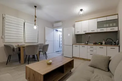 a living room and kitchen with a couch and a table at 4-teen in Jagodina