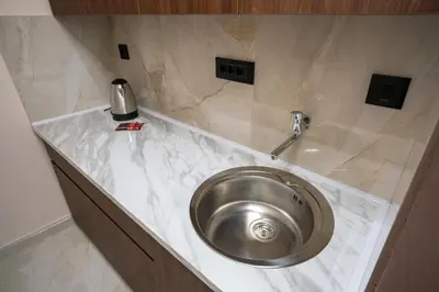 a stainless steel sink in a counter in a bathroom at Trpeza Luxury Apartments, free parking in Niš