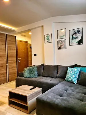 a living room with a couch and a coffee table at Milmari P87 Apartman in Cajetina
