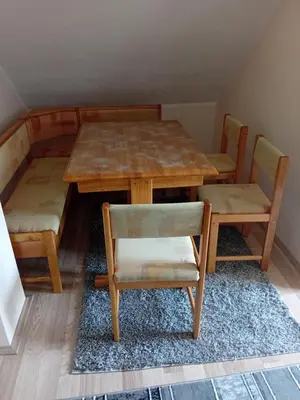 a wooden table and chairs with a table and a table and chairs at Apartman Anči in Vrnjačka Banja