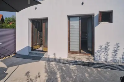 a house with three doors and a fence at Studio Melem 2 in Soko Banja