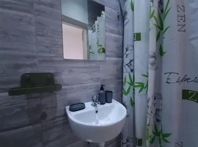 a bathroom with a white sink and a mirror at Studio Melem 2 in Soko Banja