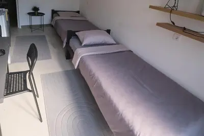 a row of beds lined up in a room at Studio Melem 3 in Soko Banja