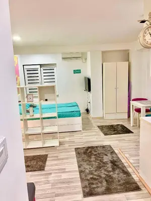 a room with two bunk beds and a table at City Center Sweet Apartment in Niš