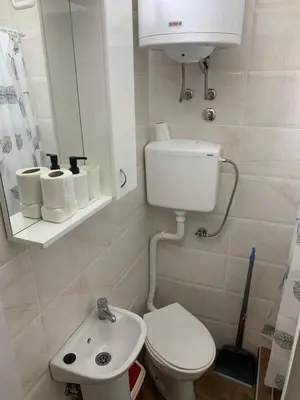 a small bathroom with a toilet and a sink at Studio Ukras in Vrnjačka Banja