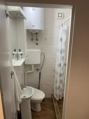 a small bathroom with a toilet and a sink at Studio Ukras in Vrnjačka Banja