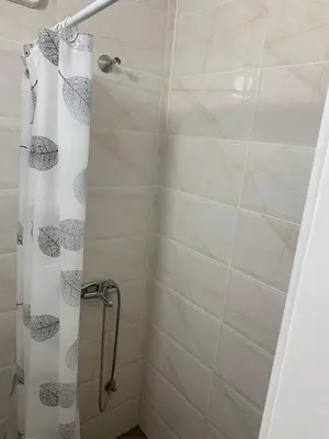 a shower with a shower curtain in a bathroom at Studio Ukras in Vrnjačka Banja