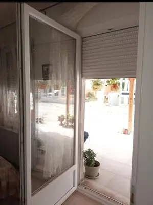 a sliding glass door with a view of a patio at Apartman Djordjevic in Vranje