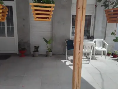 a patio with a table and chairs and a table and chairs at Apartman Djordjevic in Vranje
