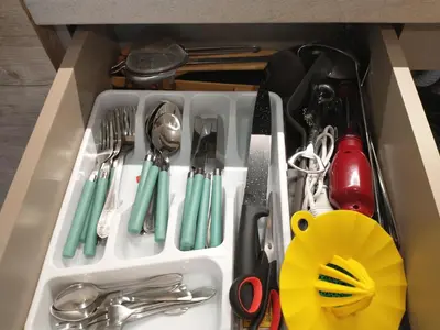 a white drawer filled with utensils in a drawer at Pavic SPA Milmari L34 in Kopaonik