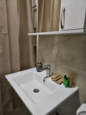 a white sink in a bathroom with a shower at Ema HILLS in Vranje