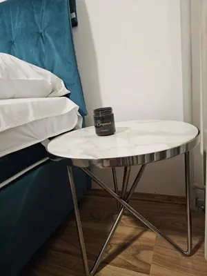 a table with a cup on top of it next to a bed at Ema HILLS in Vranje
