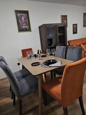 a dining room table and chairs with wine glasses at Ema HILLS in Vranje