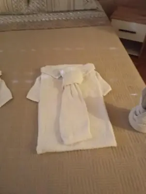 a white towel sitting on top of a bed at Apartment Aleksandrija in Niš