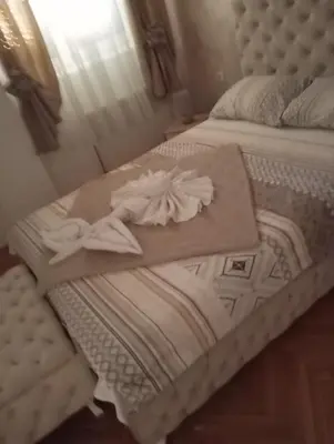 a couple of beds with towels on top of them at Apartment Aleksandrija in Niš