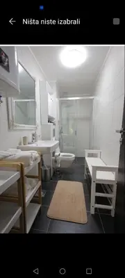 a bathroom with a sink and a toilet and a sink at Adagio Apartmani in Vrnjačka Banja